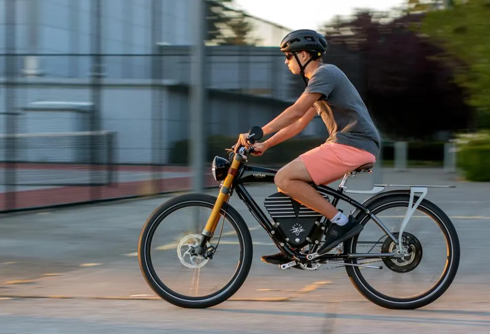 A side view of a person swiftly traveling on an e bike