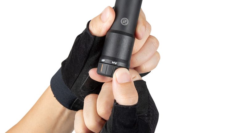 Hands with gloves holding the Topeak Mountain Stage Digital Bike Air Mini Pump 