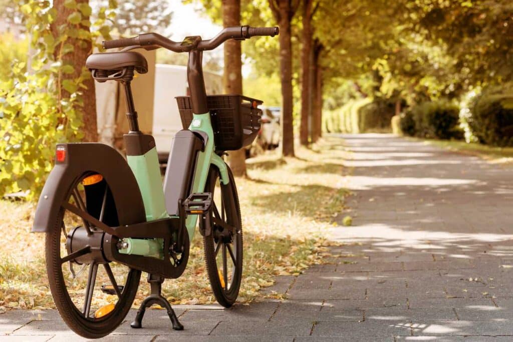 A backview of an electric bike standing in a sunny outdoors