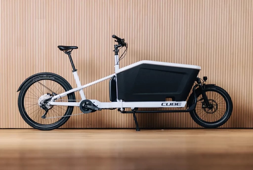 A side view of a cargo bike with a front rack