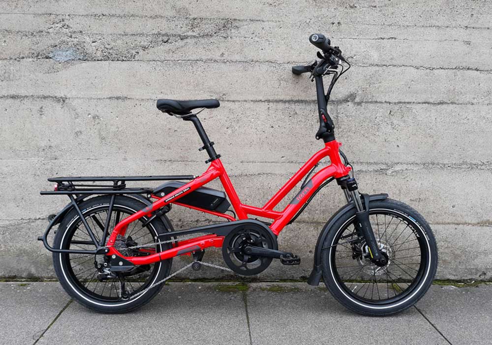 A side view of a red Tern HSD P9 cargo bike