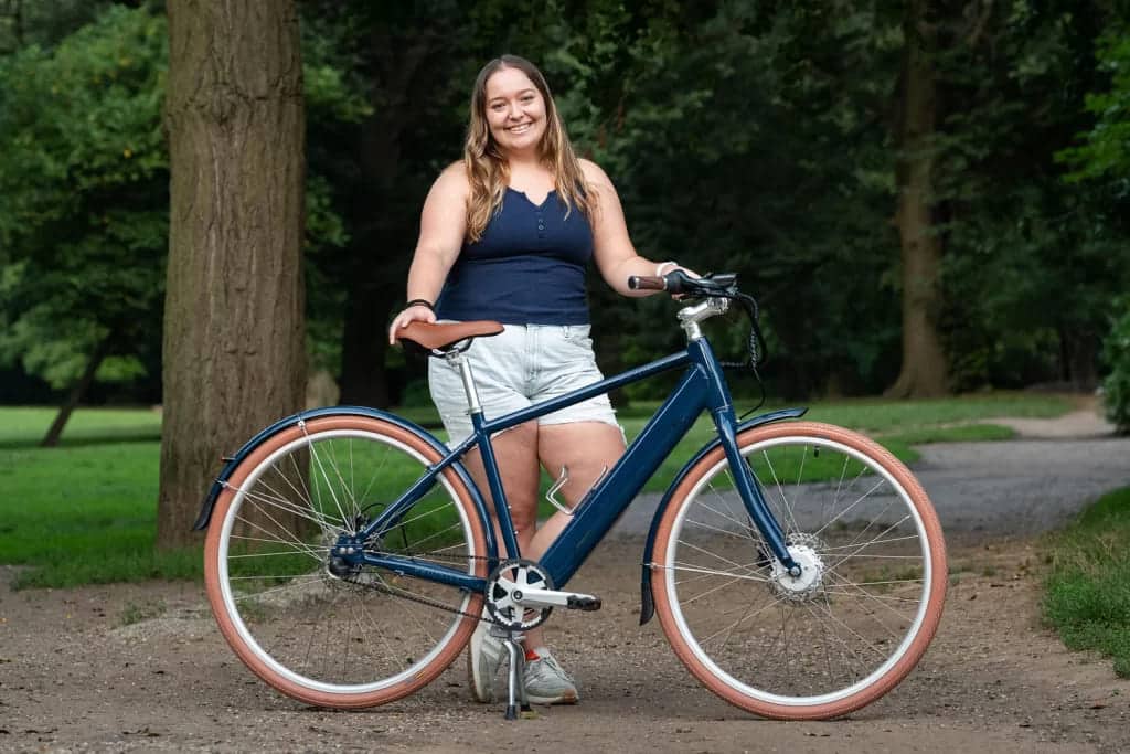 A view of a girl standing with a Priority E Classic Plus e bike