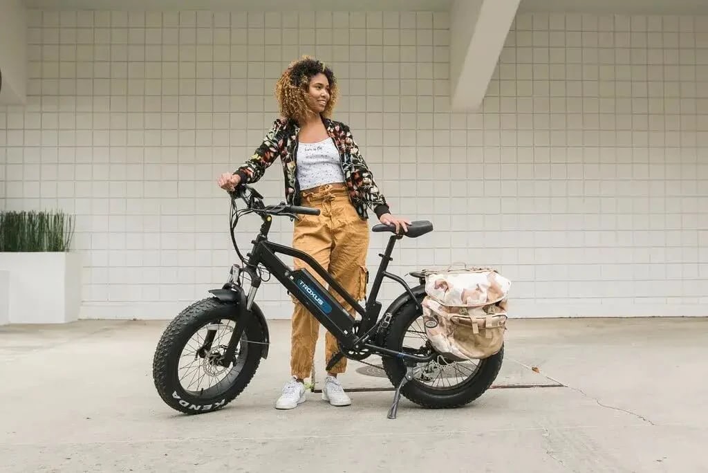 A view of a girl standing with a Troxus Sky Hopper Electric Bike 