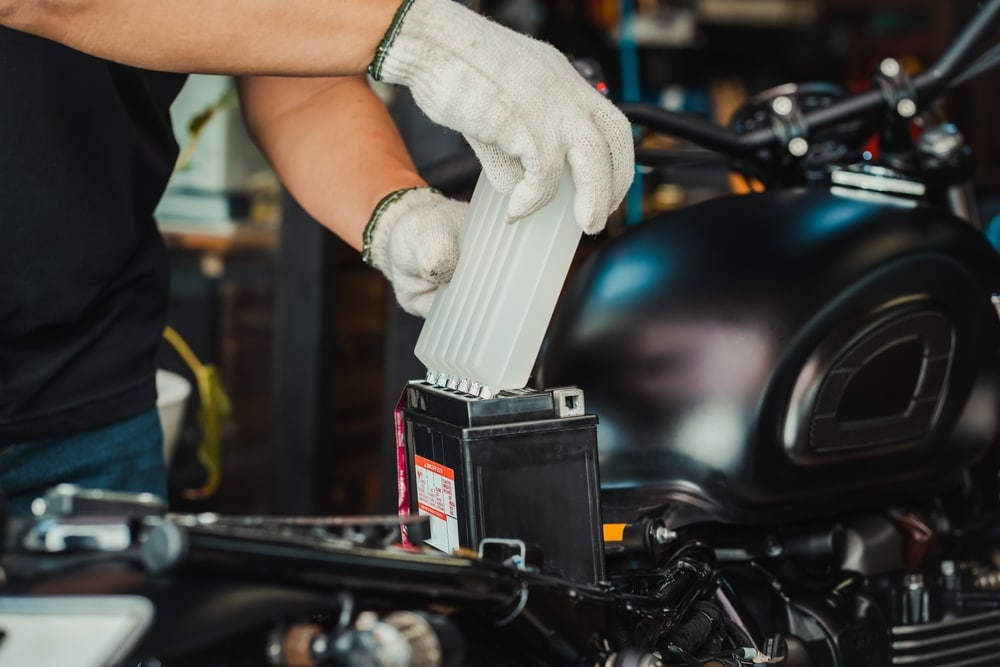 A view of a mechanic replacing battery inside an e bike