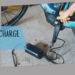 A view of a person charging a bike ( )