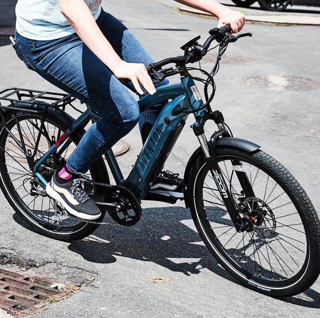 A view of a person paddling an e bike on road