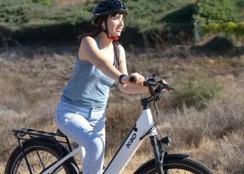 A girl with helmet riding an electric bike