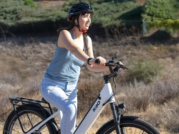 A girl with helmet riding an electric bike