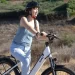 A girl with helmet riding an electric bike