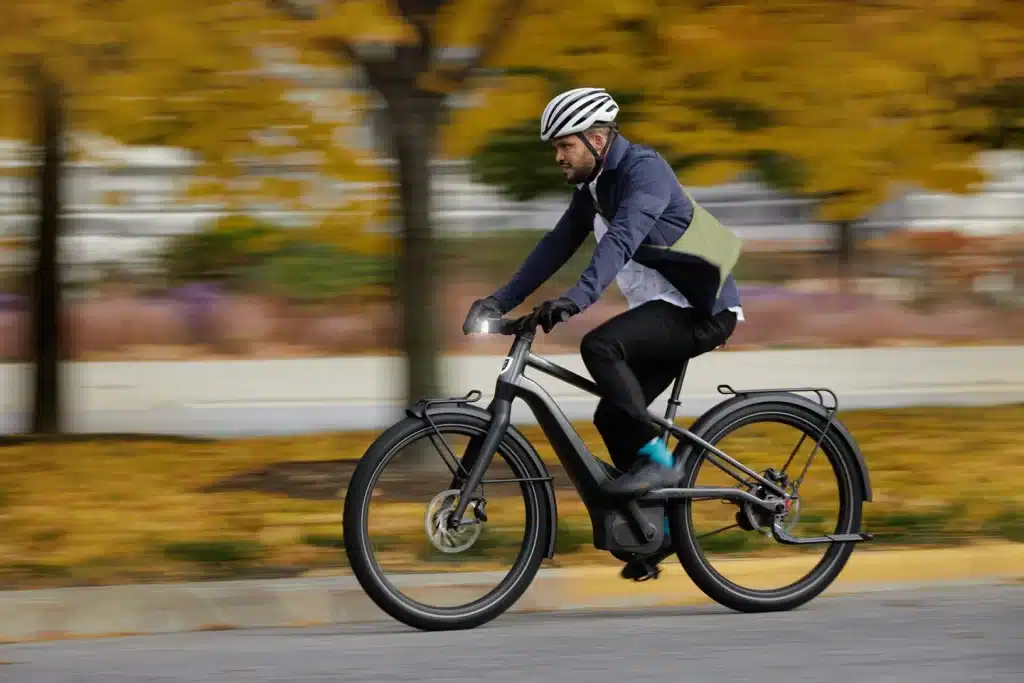 A guys riding an electric bike in speed with background blurred