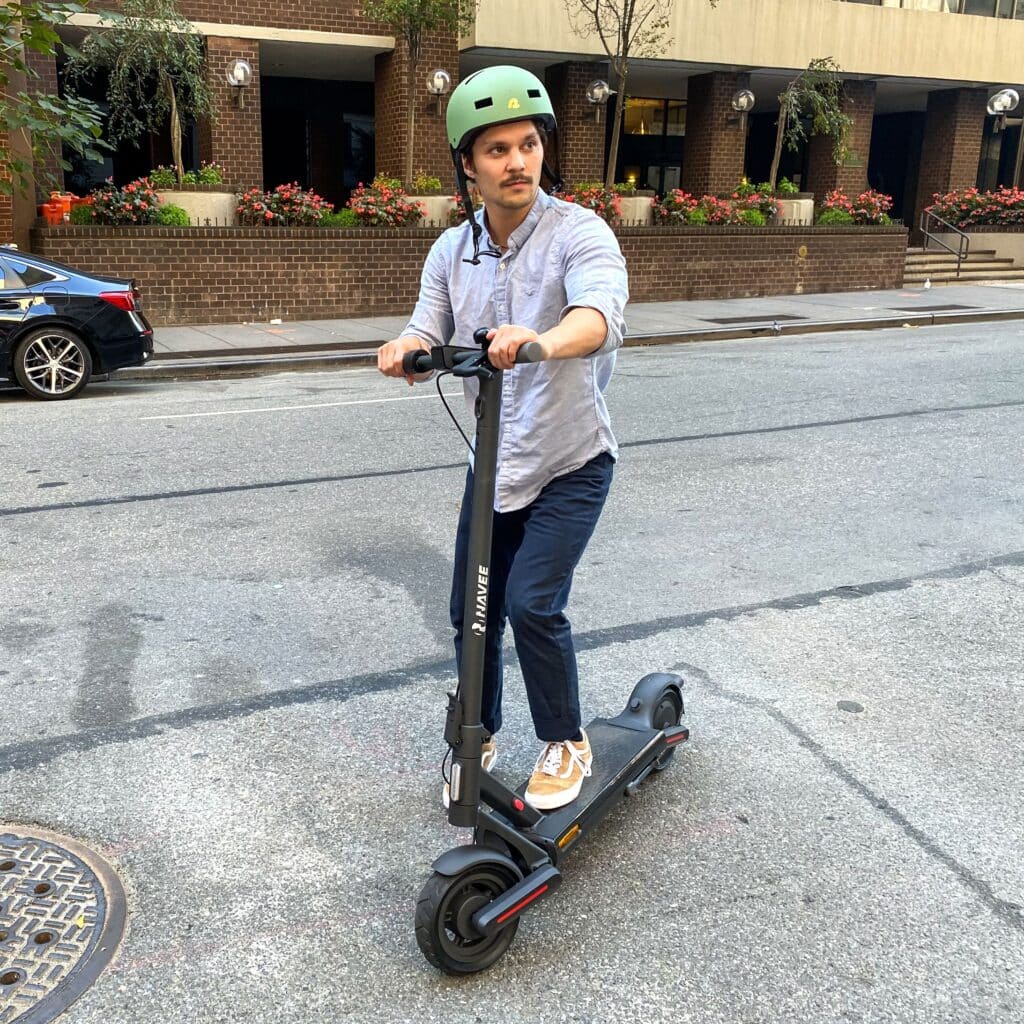 a man wearing an helmet and riding his electric scooter