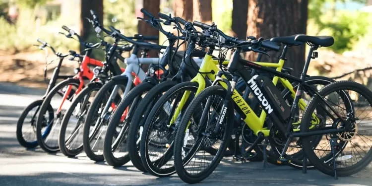 a variety of commuter bikes standing in a row
