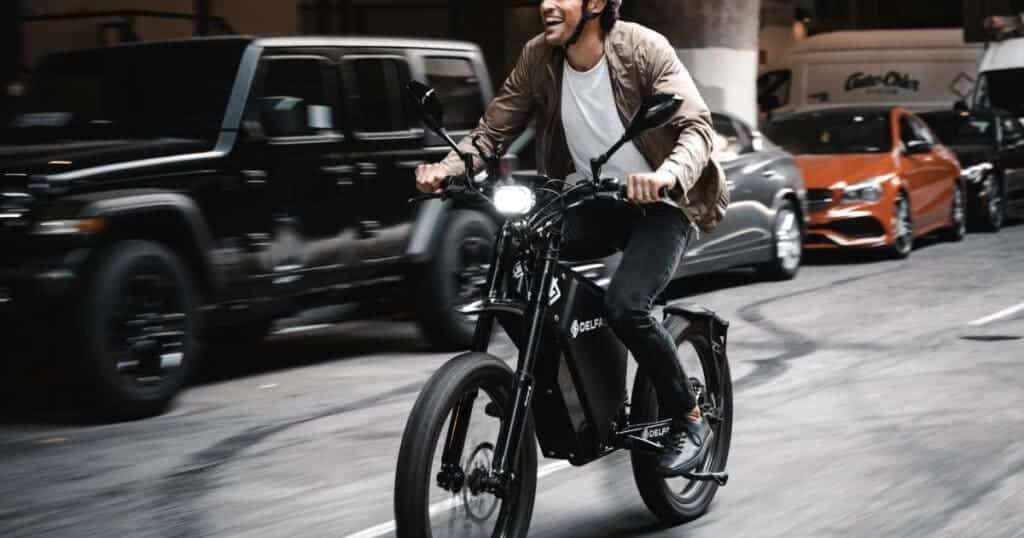 A view of a guy riding a black e bike fastly on road