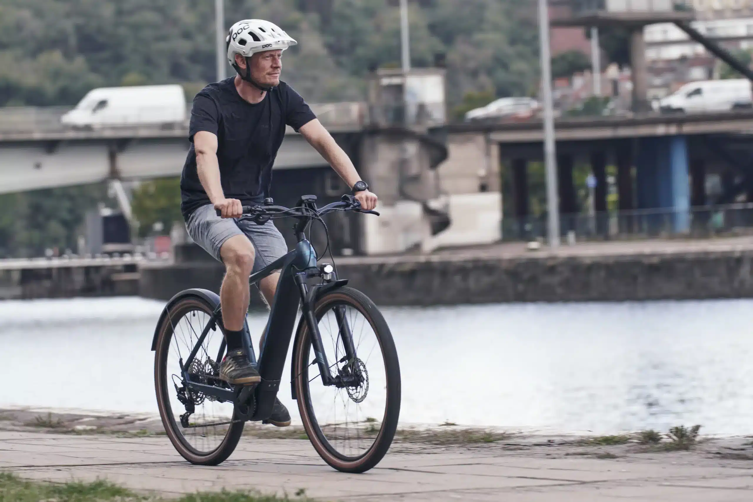 A view of a guy riding an e bike by the sea side