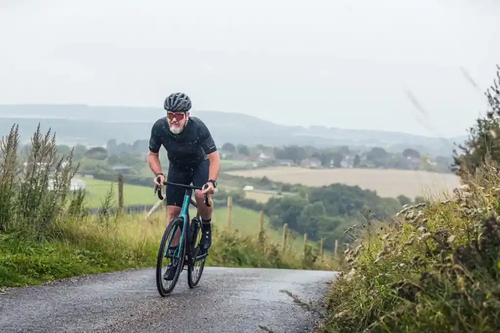 A view of a guy riding an electric bike up the road