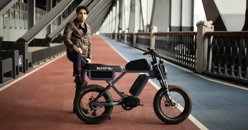 A-view-of-a-person-standing-with-an-electric-long-range-bike-indoors-1024x536