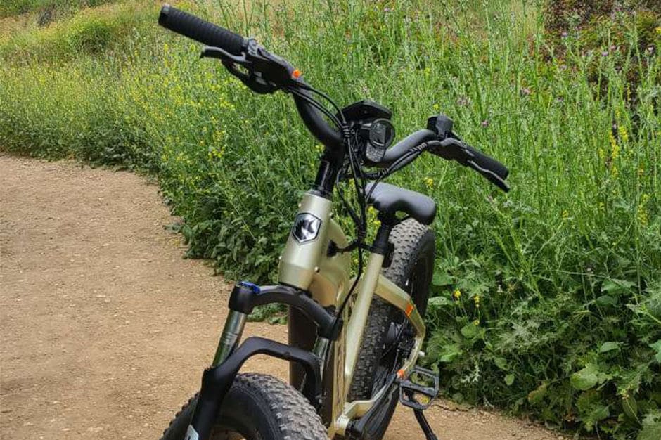 A view of an e bike parked in a grassy field