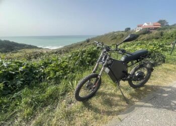 A view of an electric bike standing at a distance grassy place