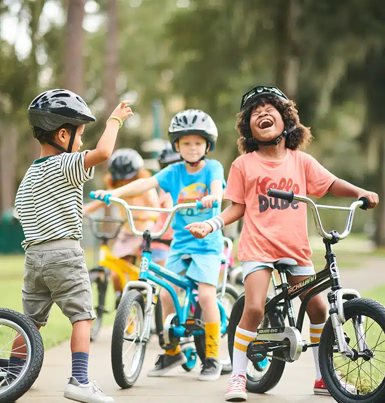 A view of kids laughing and riding bikes