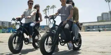 A view of two pair of people riding two seater electric bike