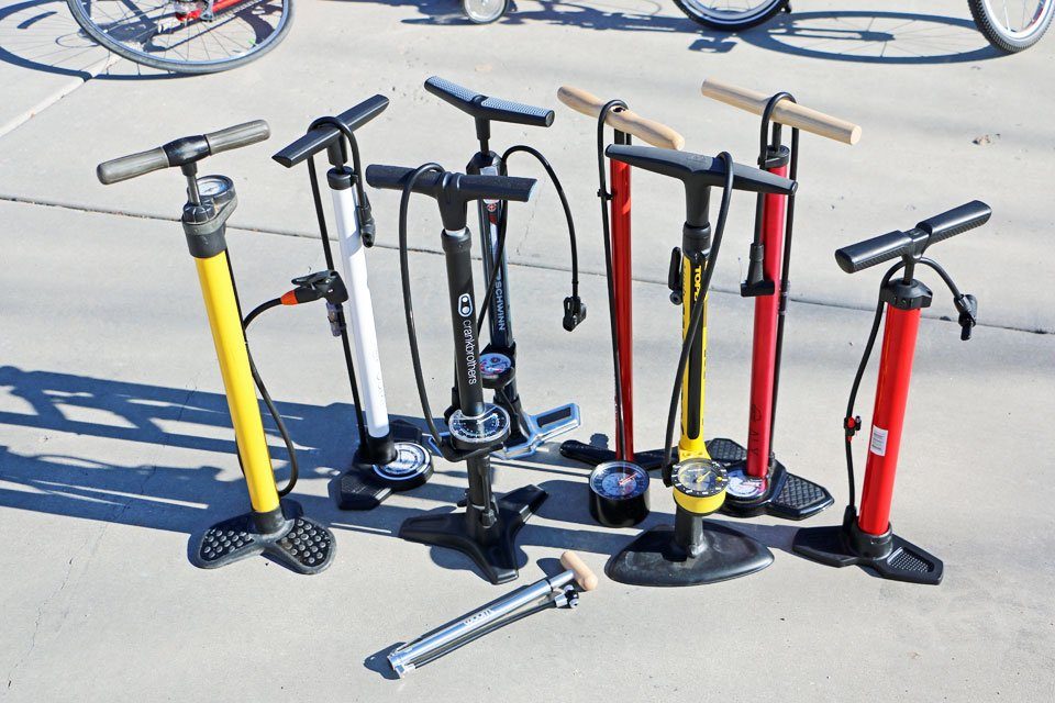 A view of a person pumping a bike tire ( )