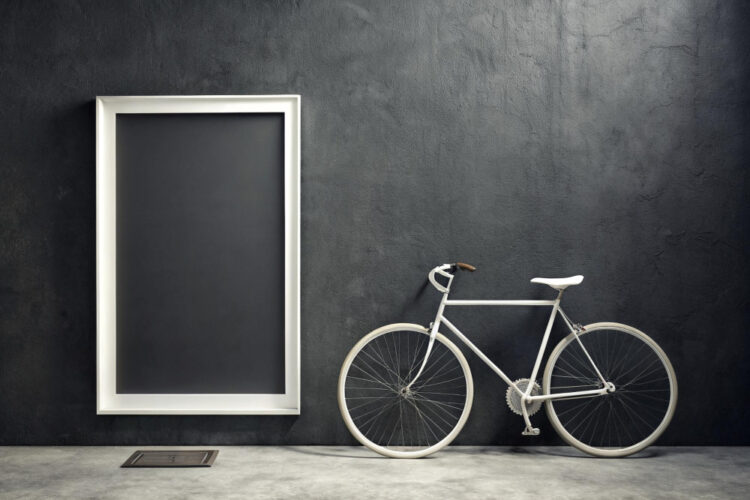 A view of a white bike alongside a white frame