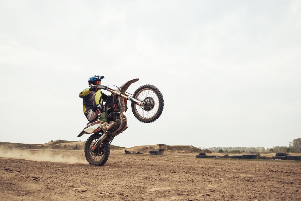 A view of a biker riding bike on a muddy road