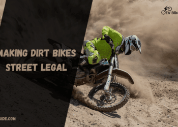 A view of a person riding a dirt bike on a muddy road ( ) ( )