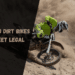 A view of a person riding a dirt bike on a muddy road ( ) ( )