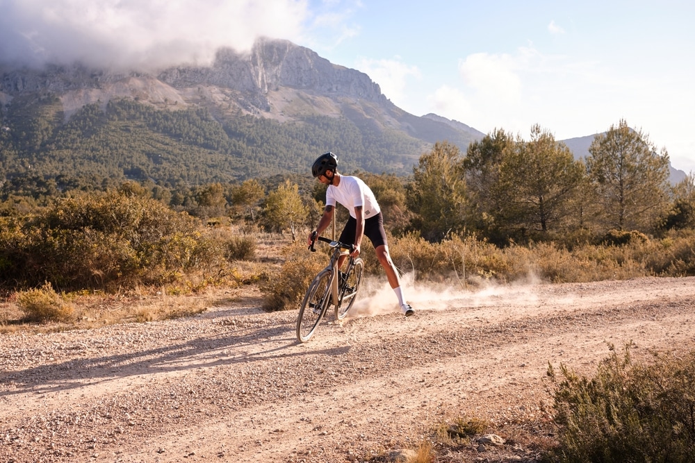 A view of a person riding gravel bike in mud