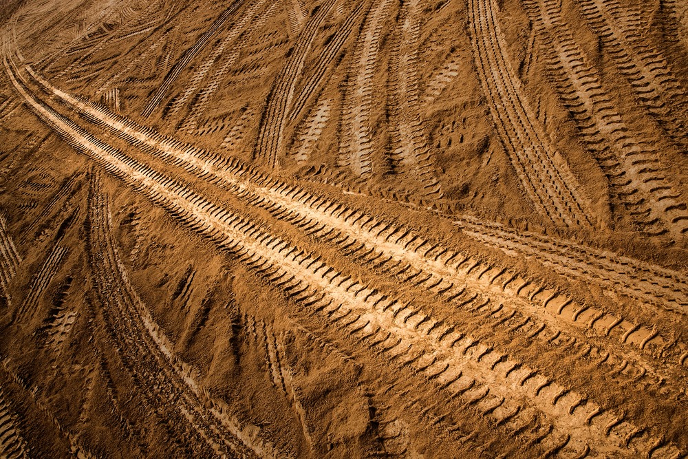 A view of dirt bike tracks on mud