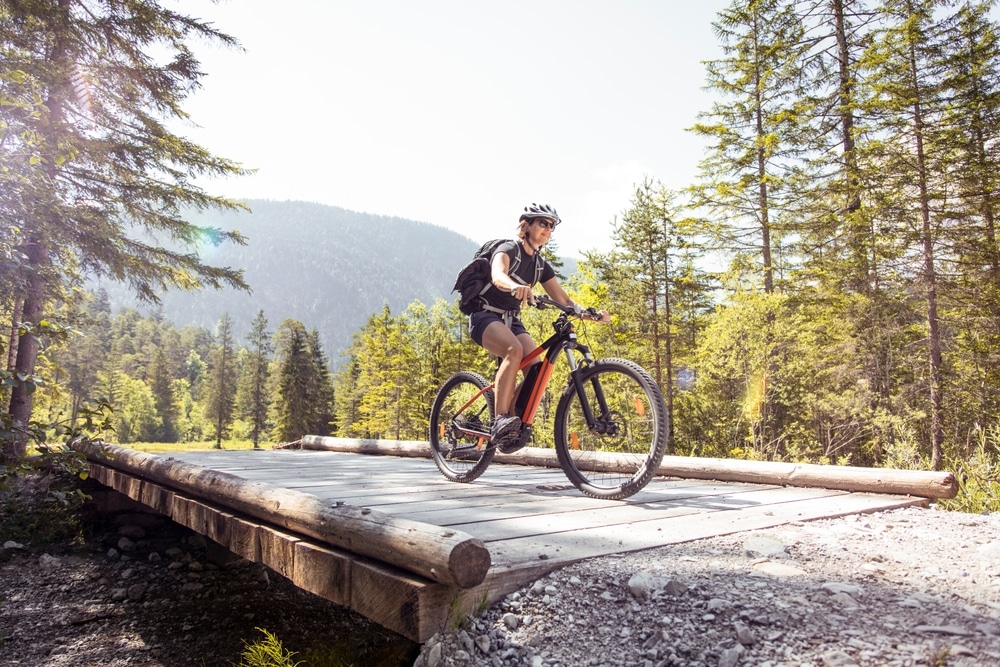 A view of a person riding an e bike on a rocky path