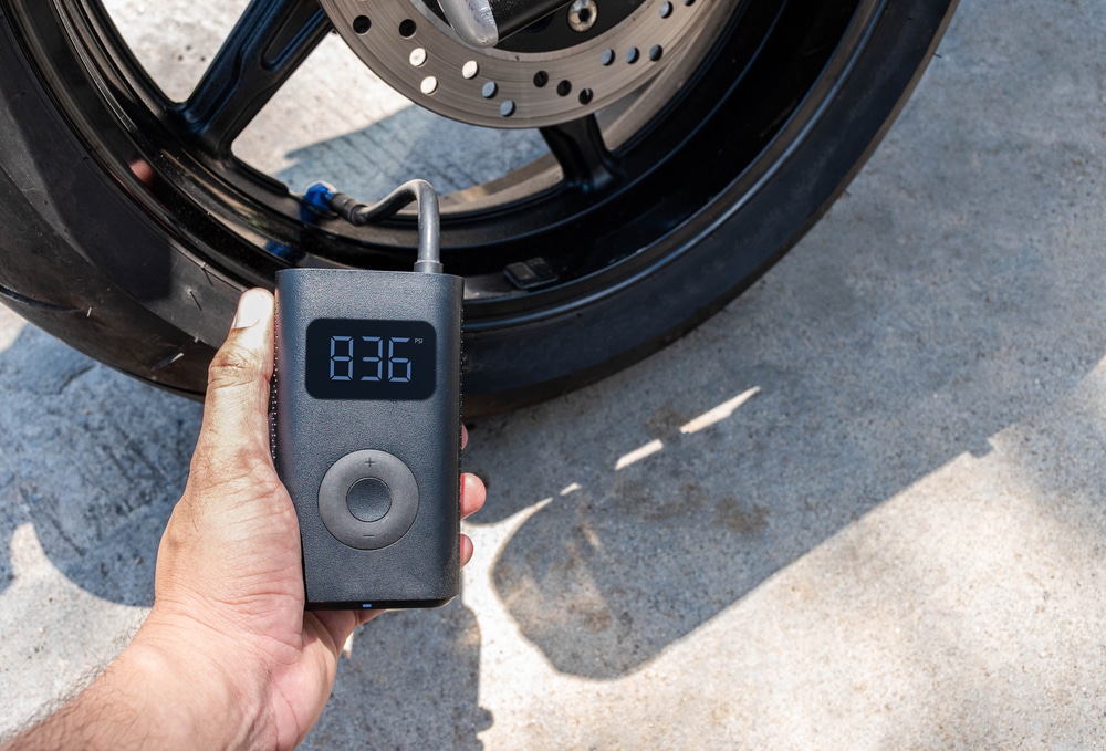 A view of a person holding a portable bike pump A view of a person holding a portable bike pump