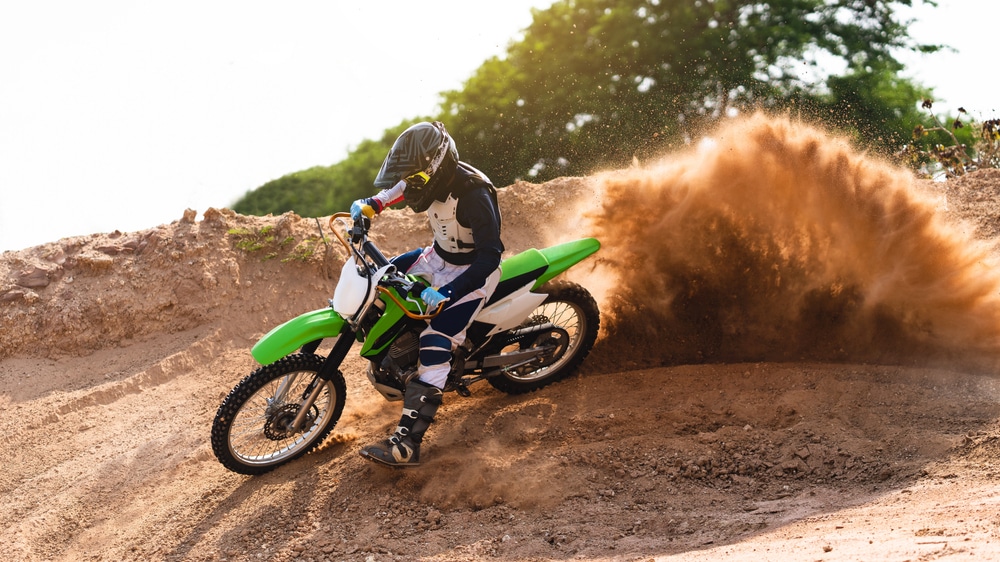 A view of a person racing a dirt bike in mud A view of a person racing a dirt bike in mud