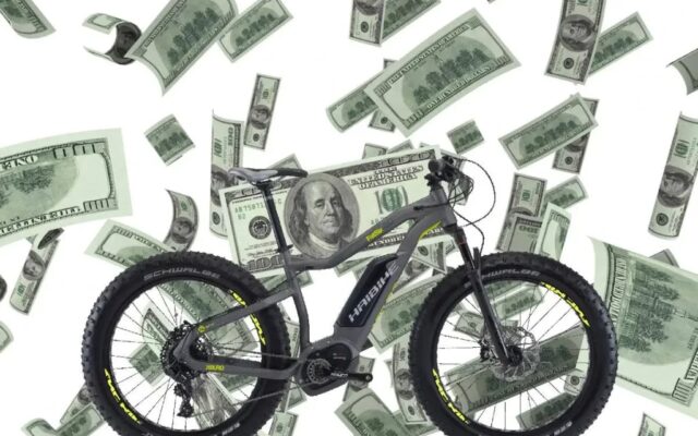 A view of an electric bike with money dollars in the air